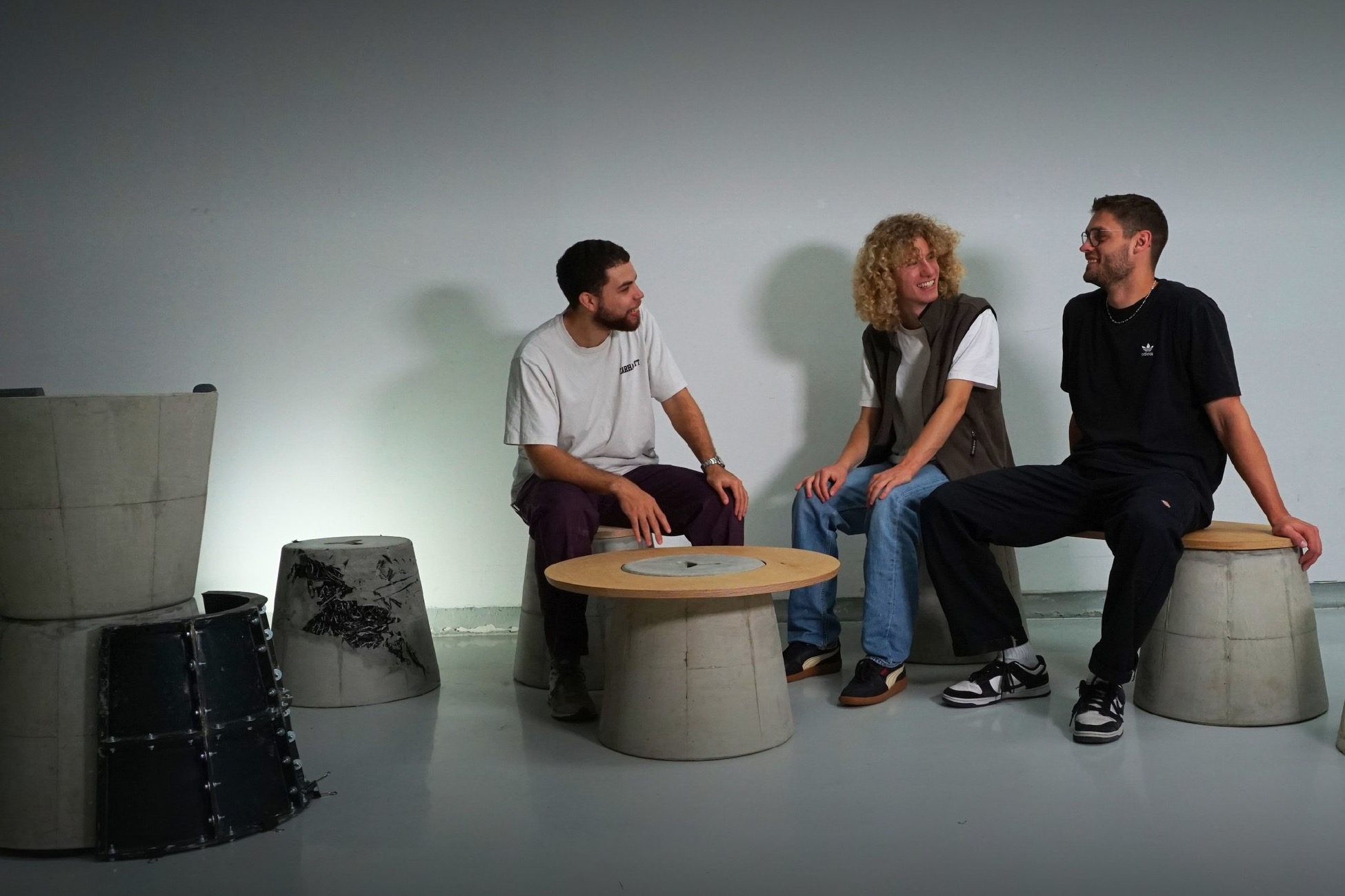 Three people sitting on CeeBee concrete stools