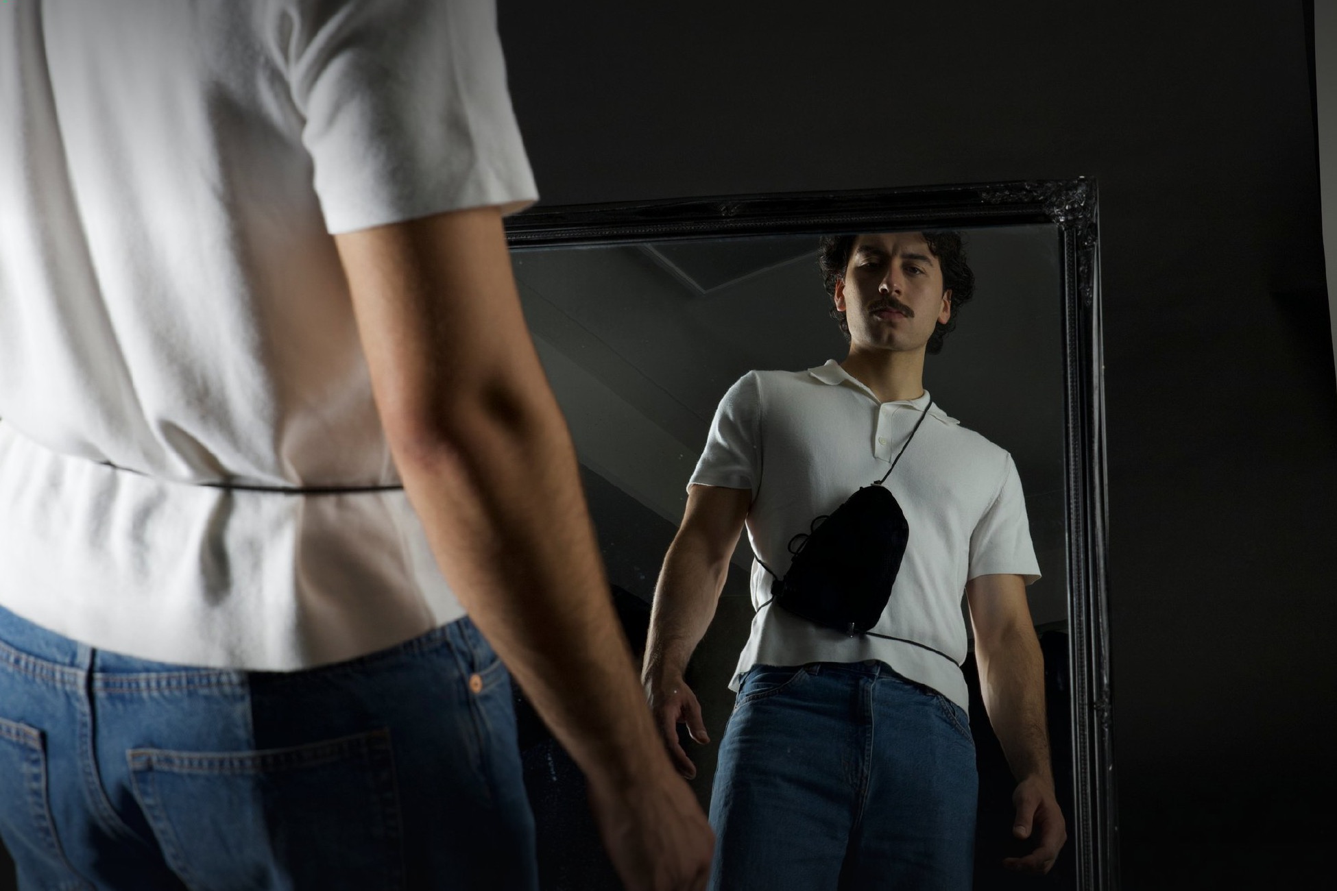 Kangoo — worn crossbody, seen in a mirror